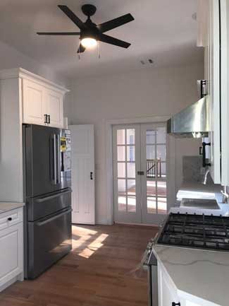 new glass doors separating the dining room from the kitchen